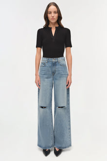 Light wash straight-leg denim crop pants with ripped knee details and cropped hem.