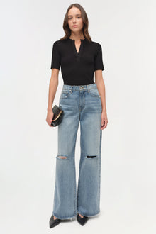 Light blue denim straight crop pants with ripped knees and distressed hem, styled with black ribbed top.