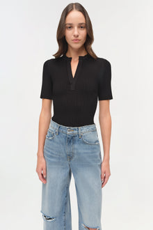 Light blue denim straight crop pants with distressed details at the knees, worn with a black ribbed top.