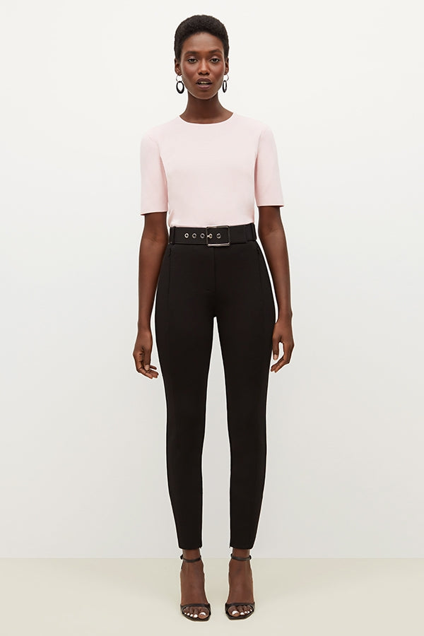 Front image of a woman standing wearing the Curie Pant--Worth in Black | Grid Hover | Exclude