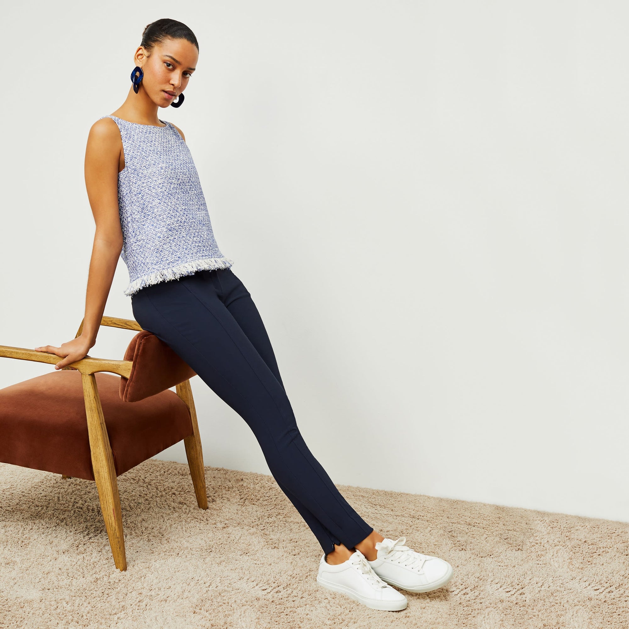 Side image of a woman standing wearing the curie pant in dark navy | Exclude