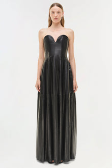 Black leather strapless bustier gown with sweetheart neckline and pleated floor-length skirt.