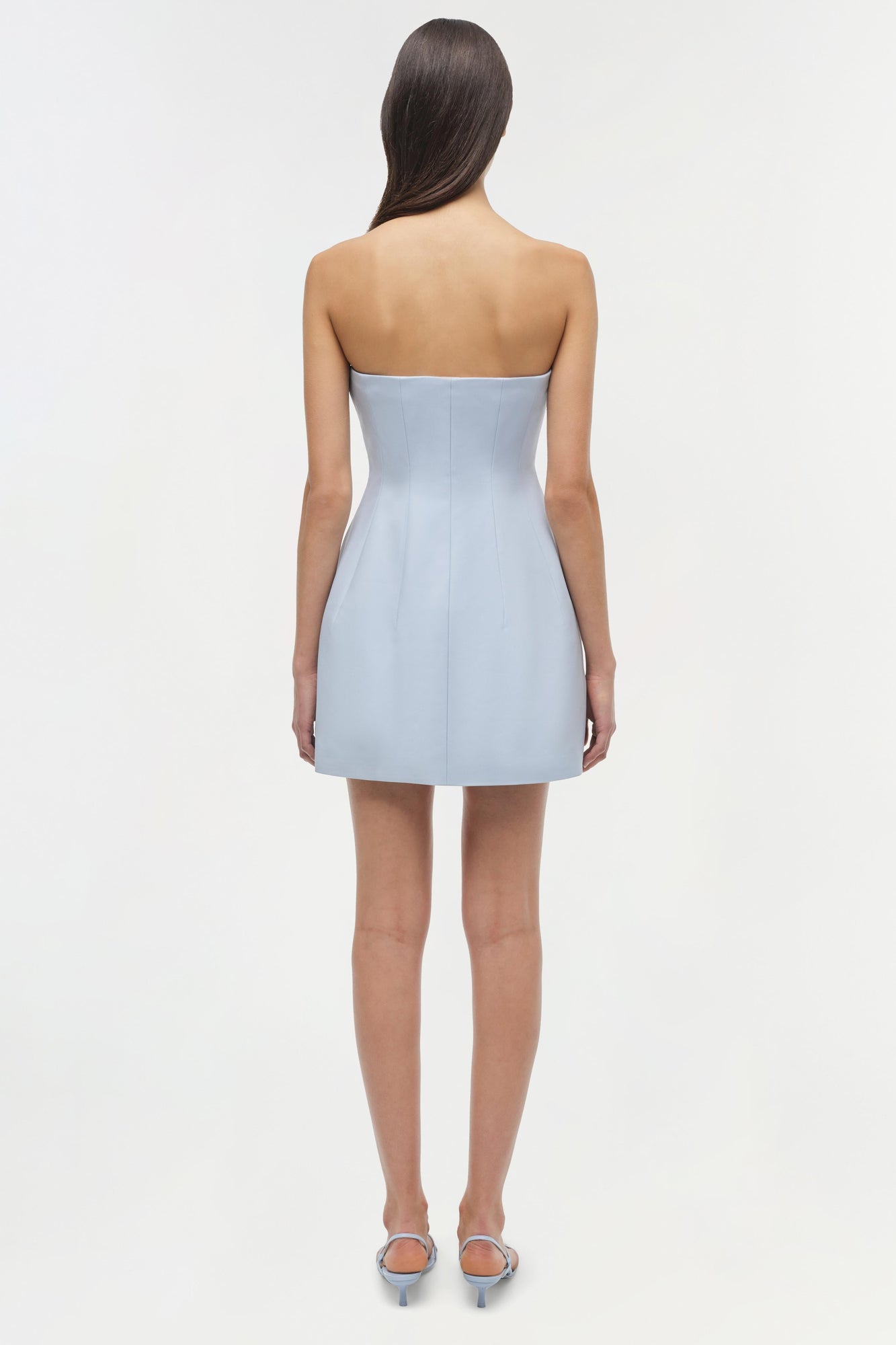 Light blue strapless mini dress with fitted bodice and A-line skirt, shown from back view on model.