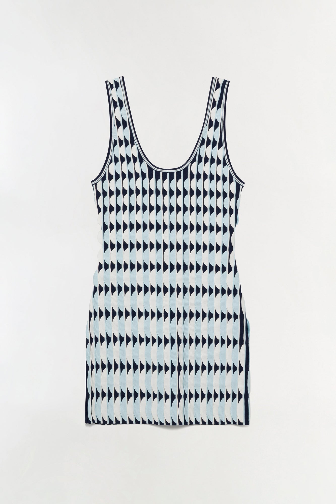 Sleeveless knit mini dress with scalloped edges in navy and white geometric pattern.
