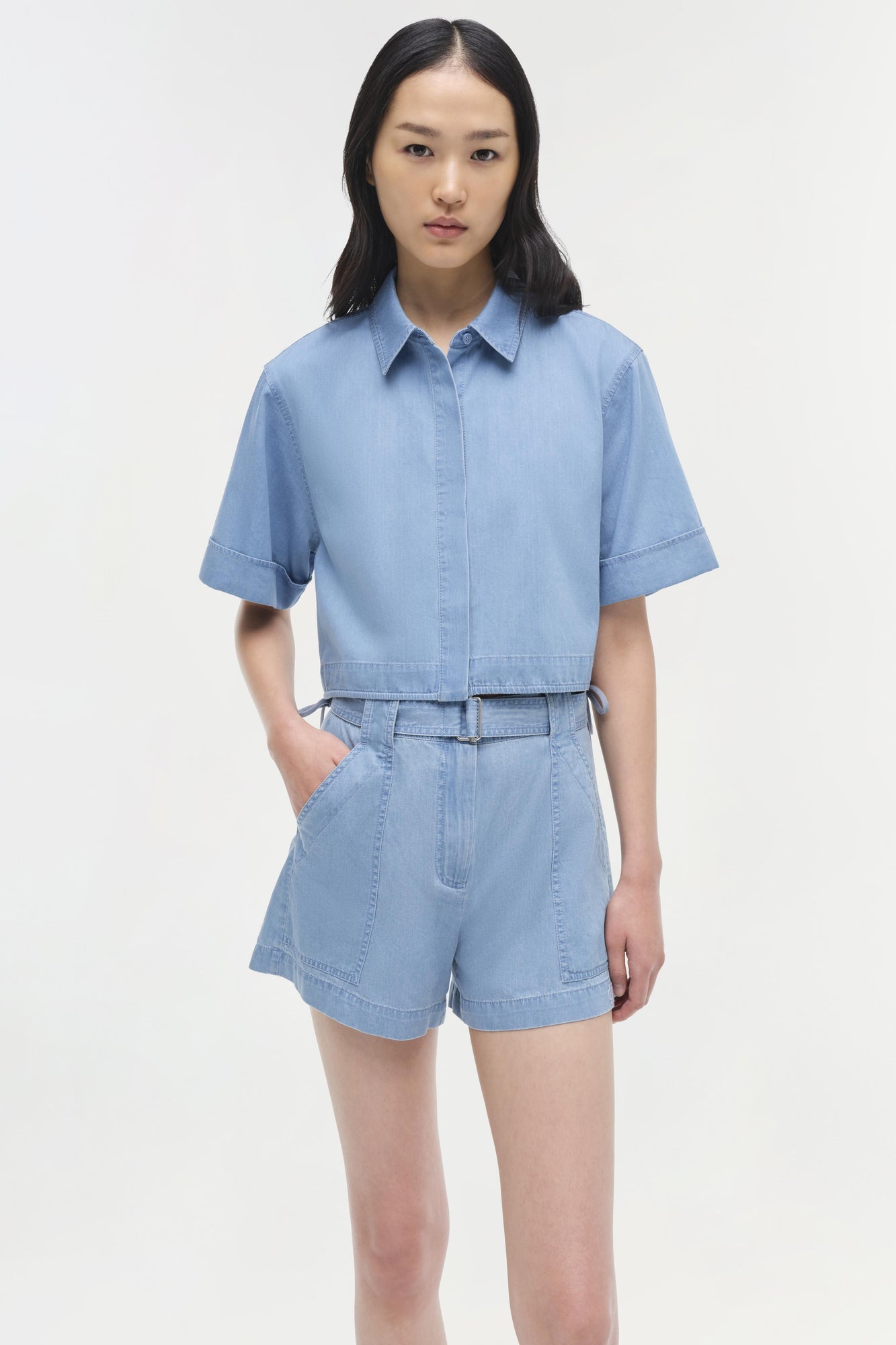 Light blue denim bishop cotton top with short puffed sleeves and collar, worn with matching shorts.
