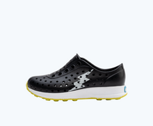 Side view of a Native Shoes Kids Robbie Sugarlite Glow Kids | Jiffy Black/ Shell White/ Shell Lightning Glow/ Pickle Speckle Rubber Footwear