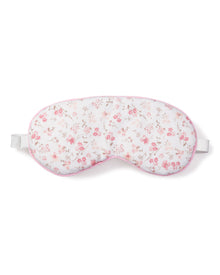 Escape to a luxury dreamland with Petite Plumes Adults Sleep Mask in Dorset Floral, featuring a floral pattern of small pink flowers and leaves, soft pink trim, and an adjustable white elastic strap for a secure light-blocking fit.