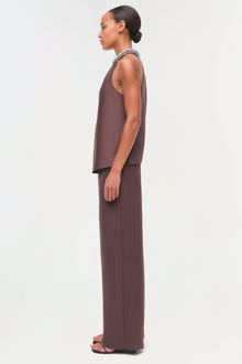 Brown satin sleeveless top with crystal embellished neckline, worn with matching wide-leg pants.
