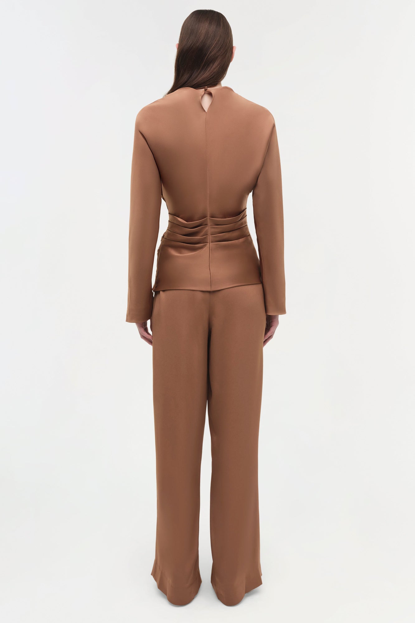 Caramel satin draped top with ruched waist detail, shown from back view on model wearing matching pants.