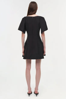 Black mini dress with short puffed sleeves and a fitted bodice with pleated skirt detail, shown from back view.
