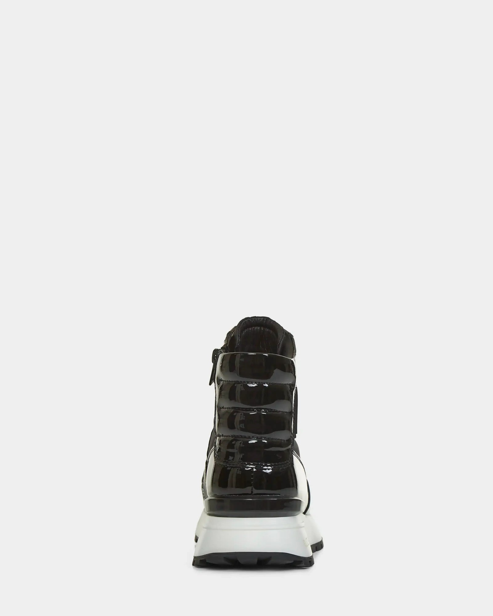 The CHELSA - L223505 Black by Rudsak is a black patent leather sneaker with a chunky white sole, shown from the back on a light gray background—perfect for any bottes baskets femmes collection.
