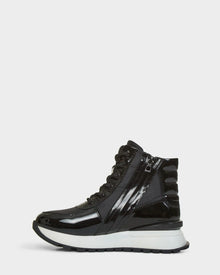 The Rudsak CHELSA - L223505 Black is a black patent leather high-top sneaker with black laces, a side zipper, and a thick white and black sole, displayed from the side on a plain white background.