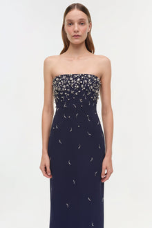 Navy strapless gown with silver beaded embellishments concentrated on bodice, scattered down skirt.