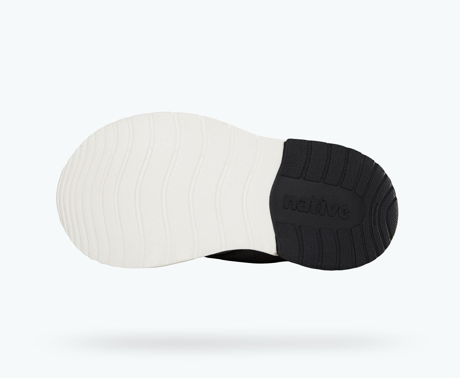 Bottom view of a Native Shoes Kids Phoenix Kids | Jiffy Black/ Shell White Footwear