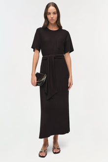 Black jersey t-shirt dress with short sleeves, chest pocket, and tied waist detail.