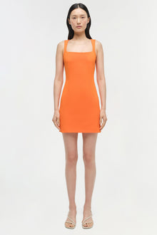 Bright orange sleeveless mini dress with square neckline on model wearing neutral sandals.