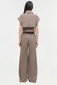 Beige cropped short-sleeve shirt with collar and wide-leg trousers, shown from back with brown belt detail at waist.