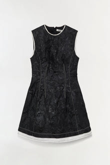 Black jacquard sleeveless mini dress with white trim at neckline and hem, featuring center seam details.