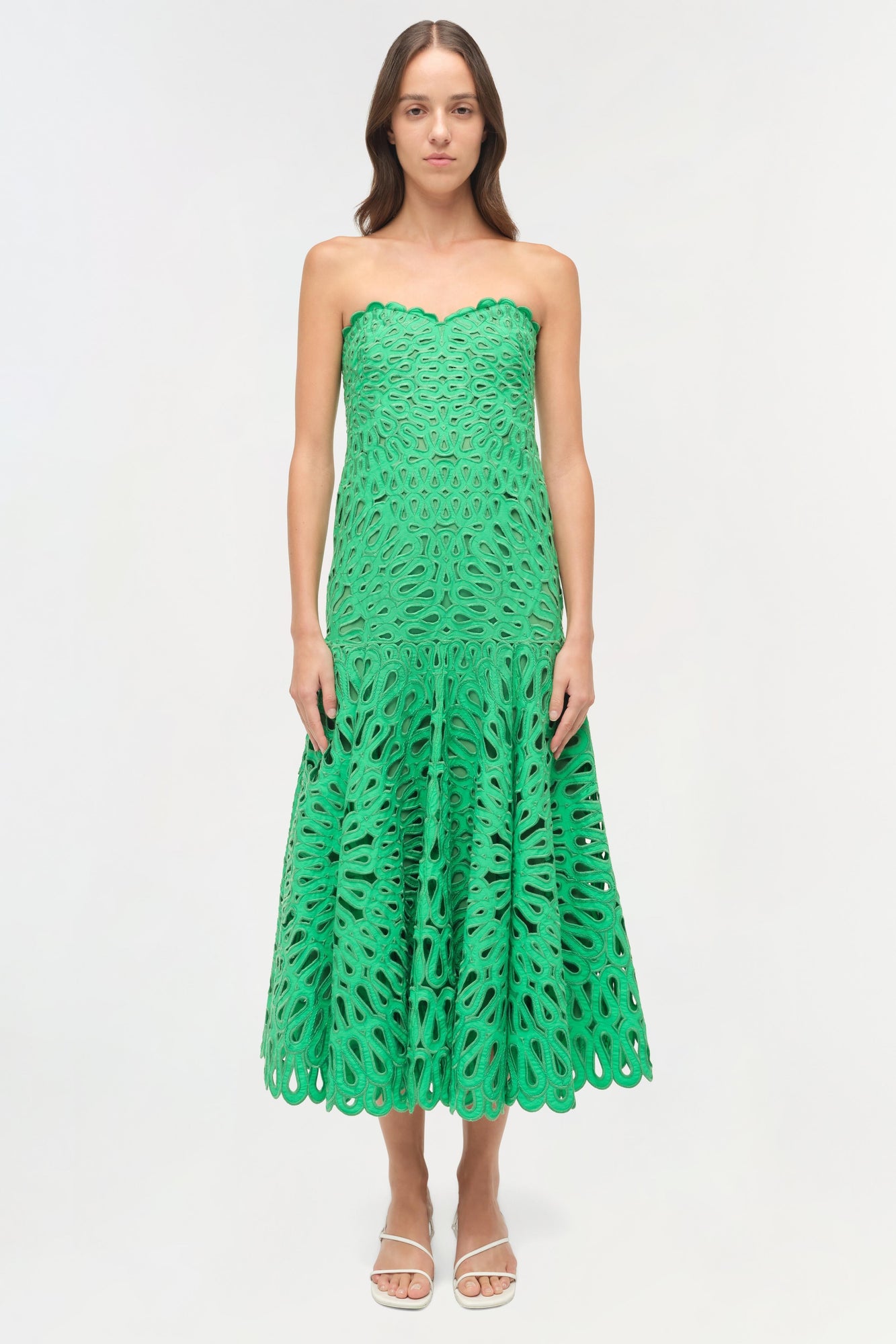 Green strapless midi dress with leaf-pattern cutout embroidery and scalloped hem.