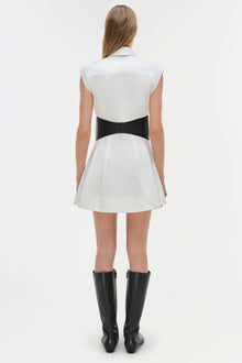 White cotton mini dress with black bow belt at waist, sleeveless collar neckline, and pleated skirt.