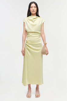 Pale yellow satin midi dress with cap sleeves, cowl neckline, and ruched waist detail on model.
