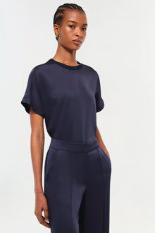 Navy crew-neck t-shirt with short sleeves on a model wearing matching navy pants.