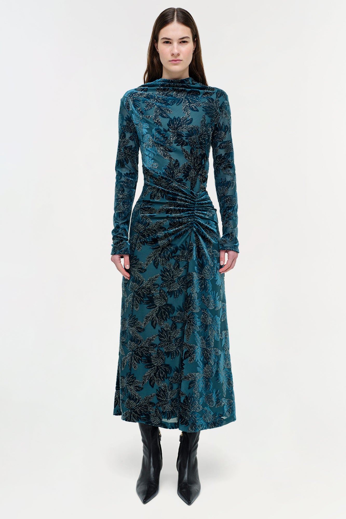 Teal velvet midi dress with black floral pattern, long sleeves, and ruched waist detail.