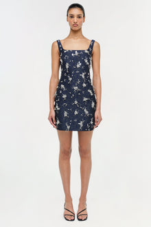 Navy mini dress with white floral jacquard pattern and square neckline, displayed on model.