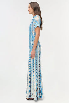 Blue and white knit midi dress with eyelet pattern and short sleeves, shown on model in side profile.