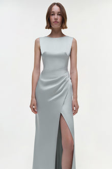 Light gray sleeveless gown with ruched side detail and high slit on model against white background.
