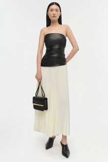 Black strapless top with ruched waist seam and cream pleated skirt midi dress.