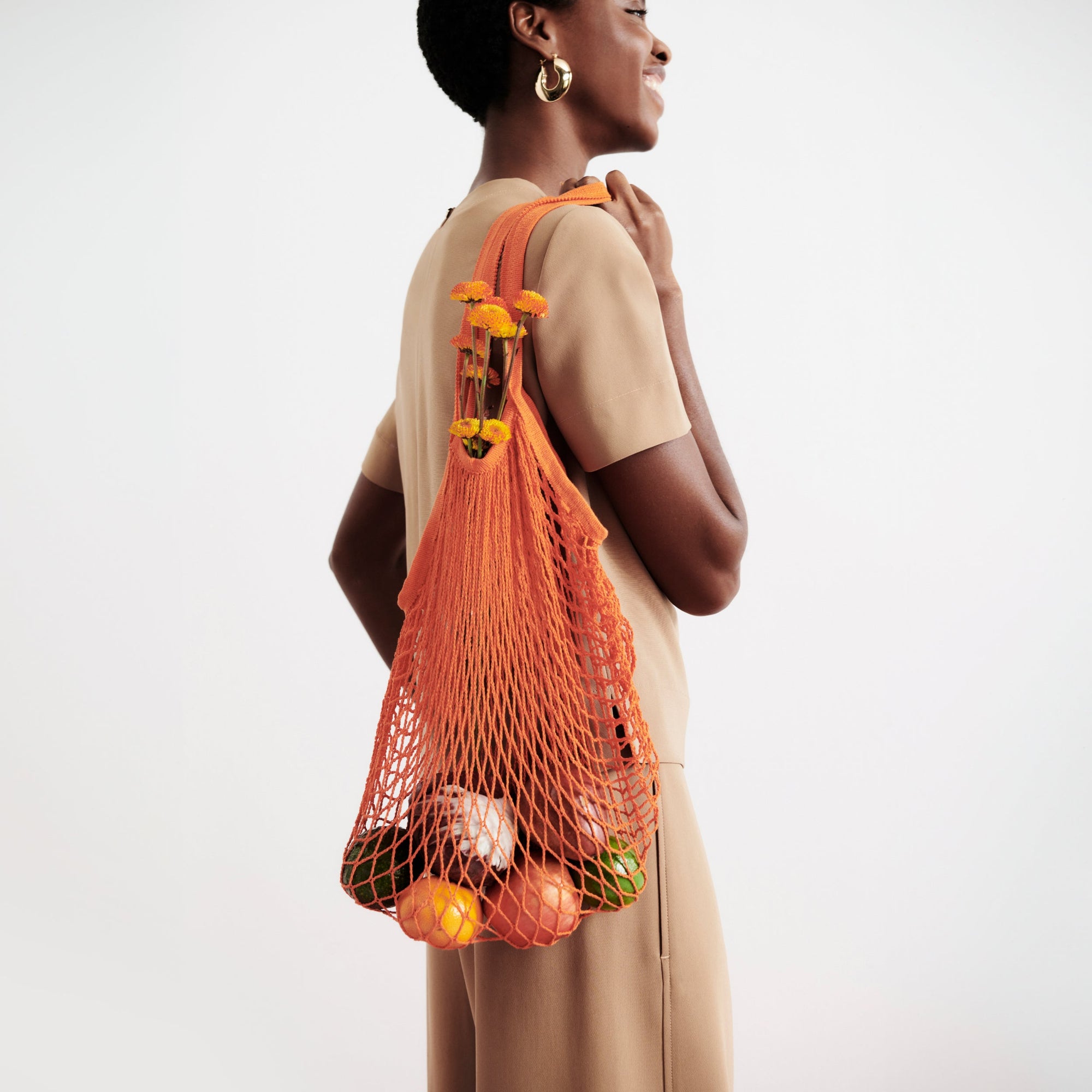 side image of a woman wearing the annika top in saddle