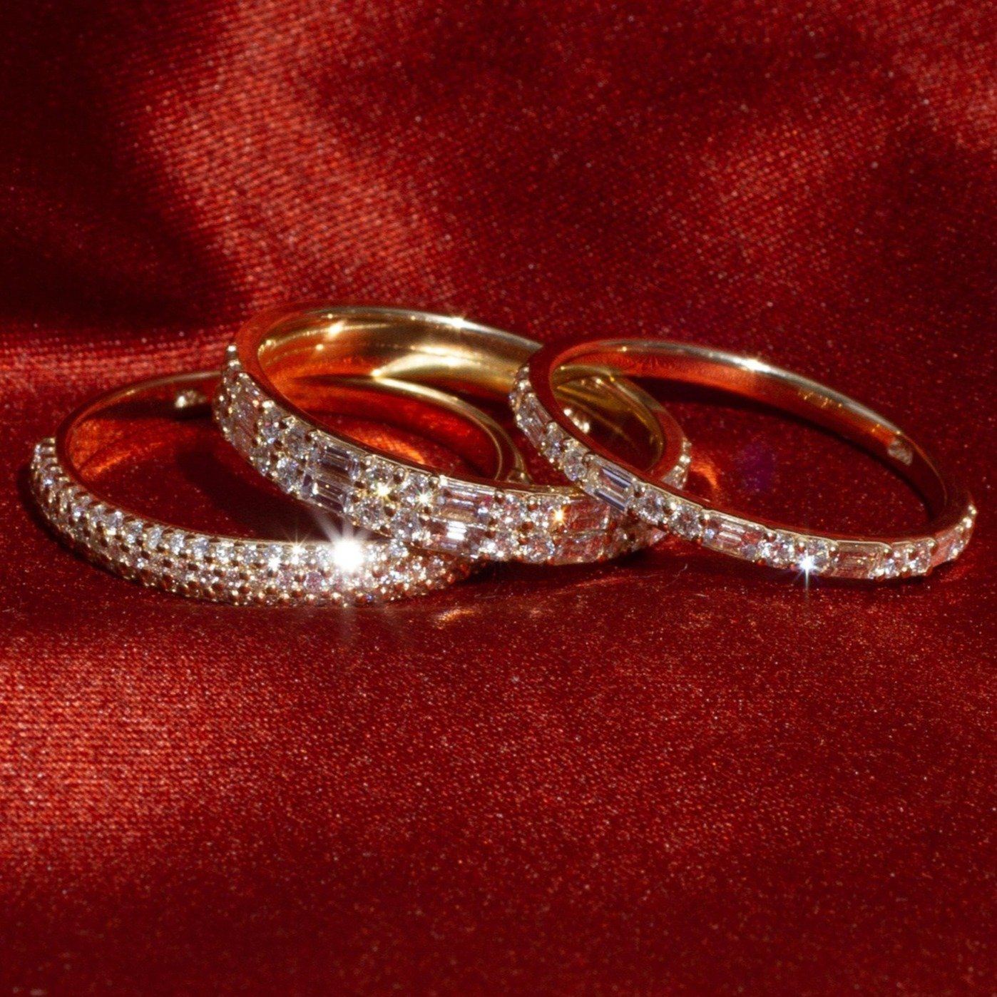 Flatlay Model. 3 diamond eternity rings on red velvet background