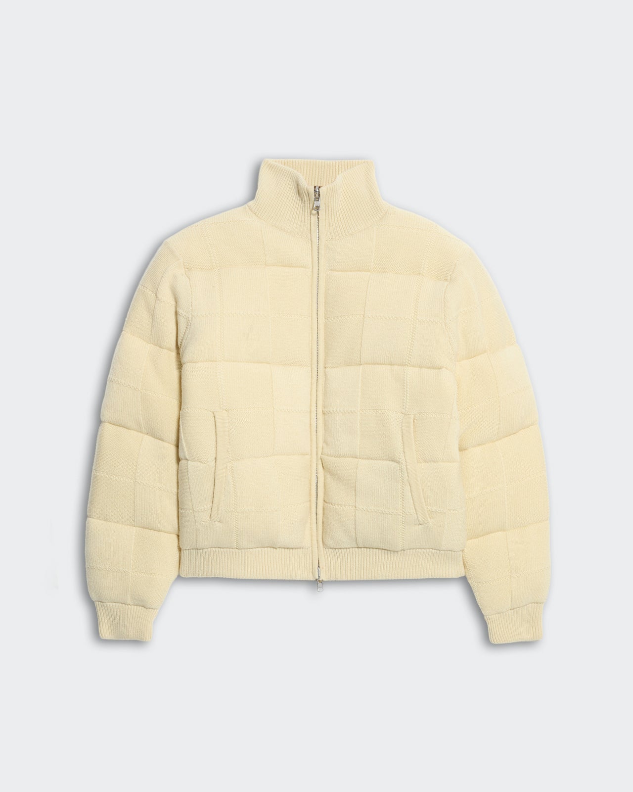 Cream quilted puffer jacket with square grid pattern, ribbed turtleneck, front zip, and side pockets for women.