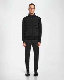 A man faces forward wearing the Rudsak EUGENE - 6124016 Black lightweight mixed-media jacket, paired with dark gray pants and black shoes, set against a plain white background.