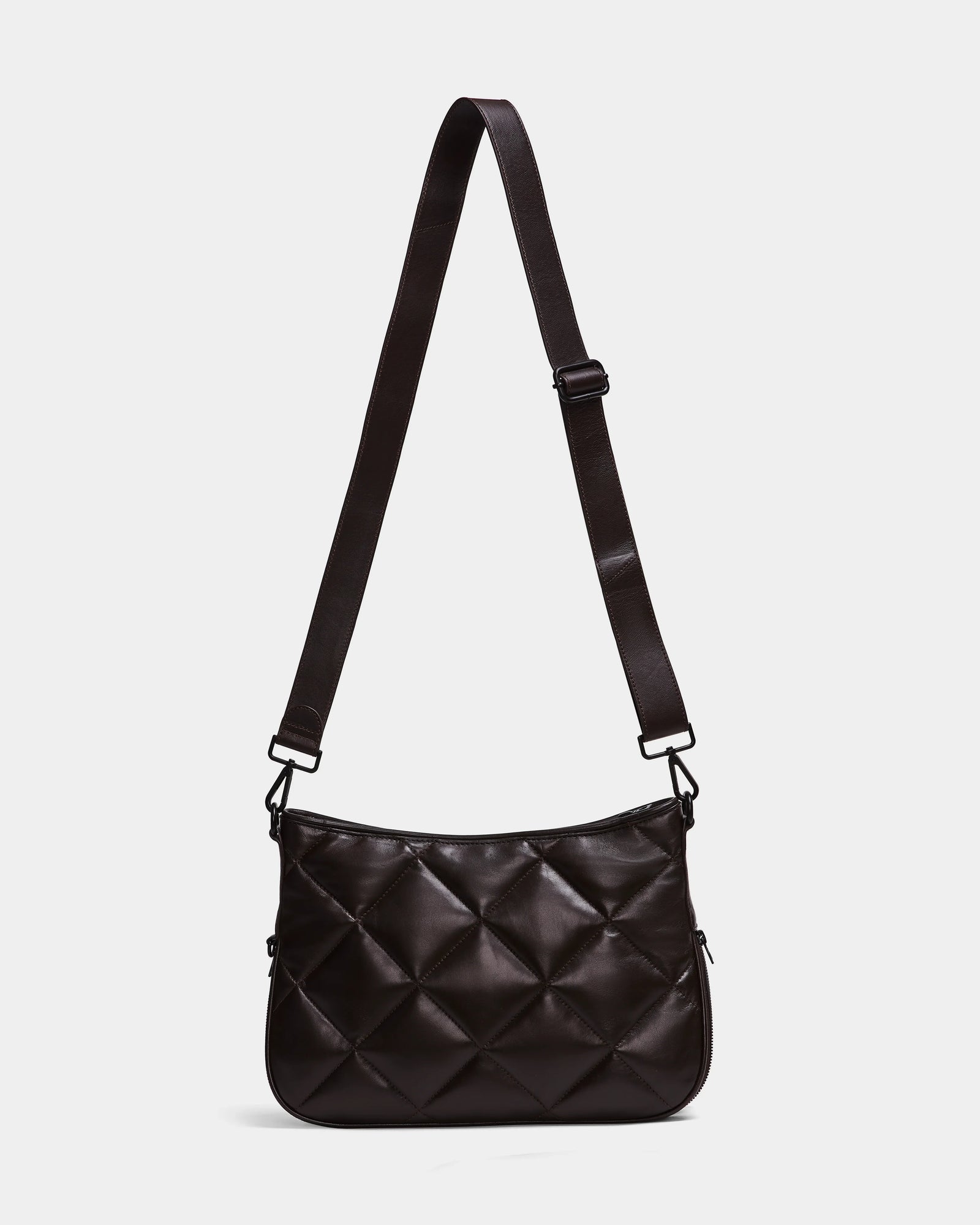 The Rudsak ALICIA - 8323507 Espresso is a black, rectangular quilted purse with diamond-pattern stitching, luxe leather, an adjustable strap, and a minimalist design displayed on a plain white background.