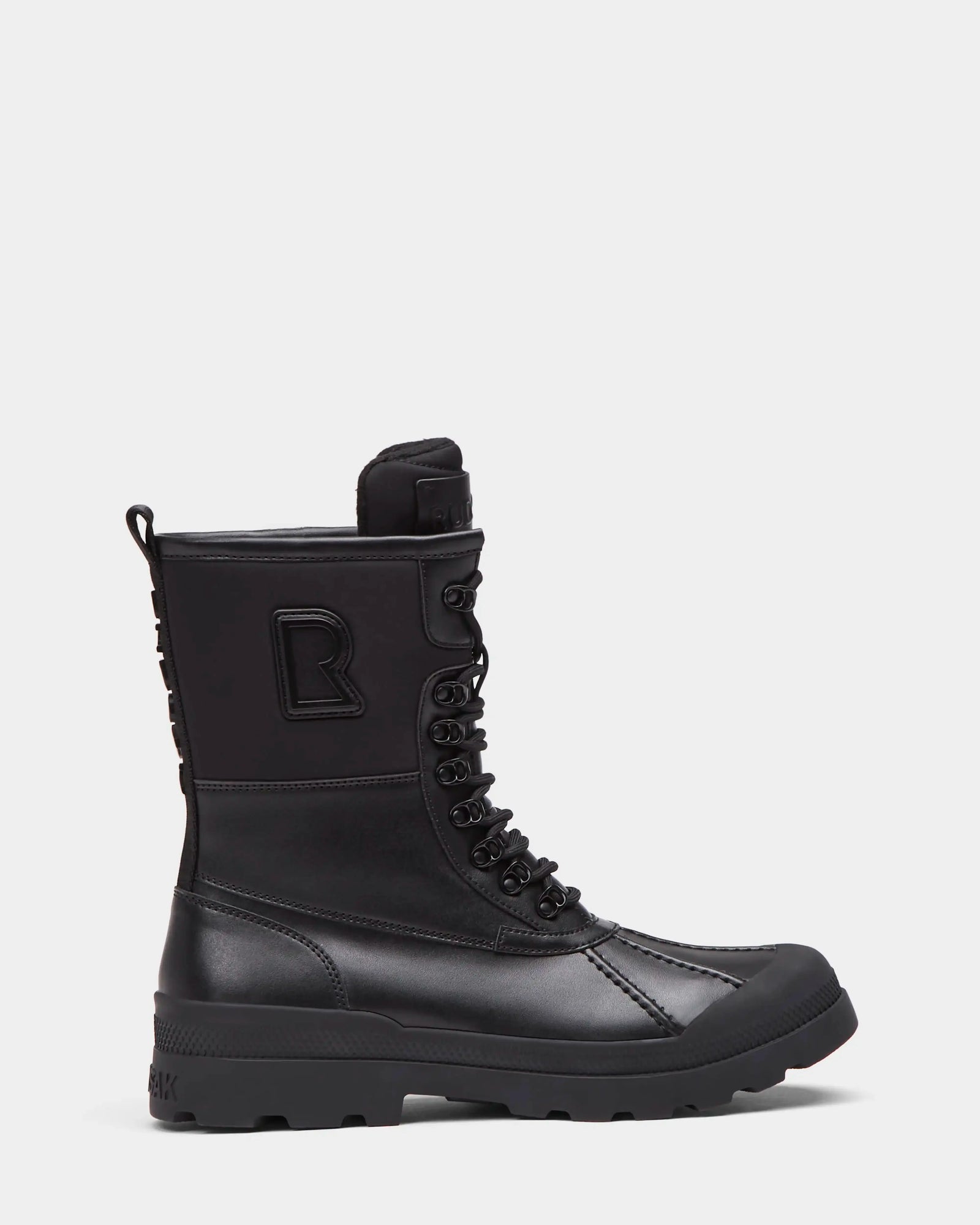 The Rudsak DAMIEN - M222500 Black is a men's mid-calf winter boot with a lace-up front, rugged sole, reinforced toe, weather-treated leather, raised R logo on the side, and back pull tab.