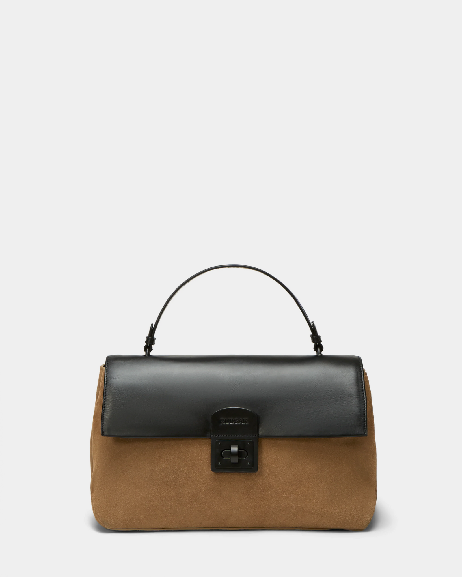 The Rudsak ESMA - 8324519 Camel is a suede leather handbag with a camel brown body, black leather flap, black top handle, black clasp closure, and a removable shoulder strap, shown against a plain light background.