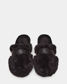 The Rudsak FLUFF - L223509 Black slippers feature cozy black faux-fur and RUDSAK branding across the straps, shown on a white background.