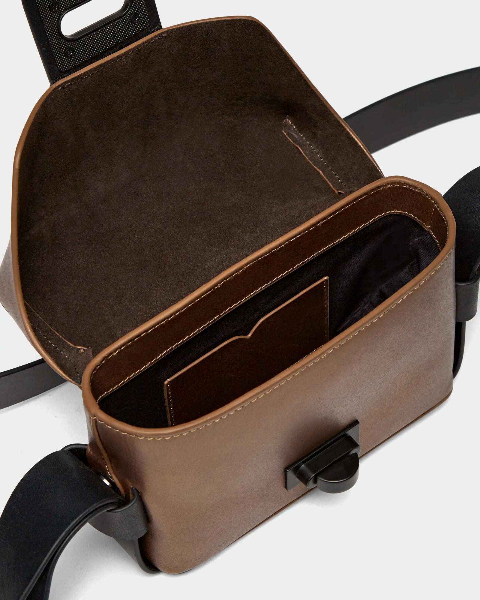 The OFILIA - 8324504 Antique Bronze by Rudsak is a brown leather crossbody bag featuring black straps and an adjustable shoulder strap.