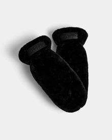 A pair of Rudsak SUSAN F - 8424507 black womens mitts featuring plush faux fur texture and a signature label on each cuff, displayed on a plain light gray background.