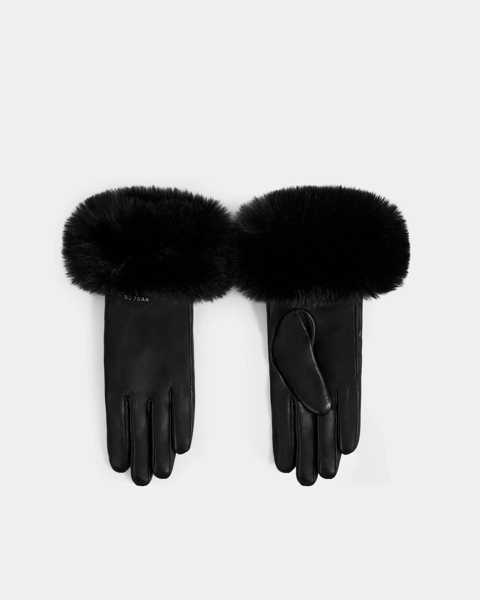 A pair of Rudsak GERRY - L425550 Black women’s gloves in rich black lamb leather, with thick faux-fur cuffs, are shown palm up and down on a plain light background.