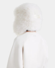The Rudsak LIDDIE - L525505 Vanilla is a large, fluffy white fur hat that covers most of the head and neck—an effortlessly chic addition to any winter wardrobe.