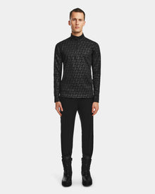 A man faces forward in the Rudsak ROMEO - 6524525 Black mock neck zip-up, black pants, and lace-up boots—showcasing sleek cold-weather activewear against a plain white background.