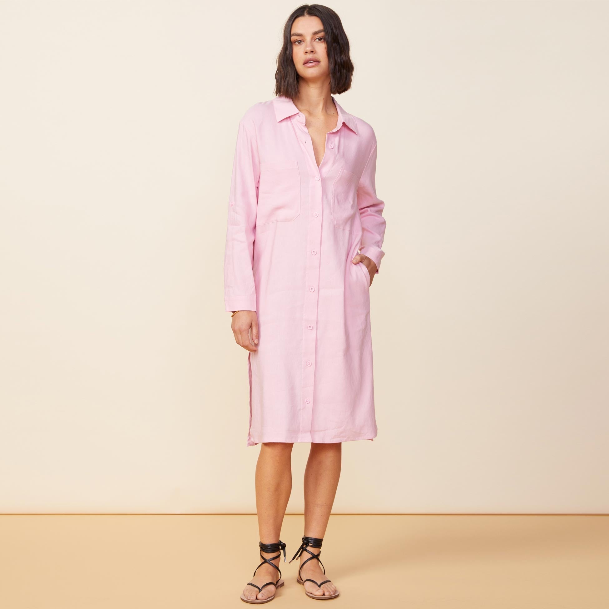 Front view of model wearing the linen shirt dress in bubblegum.