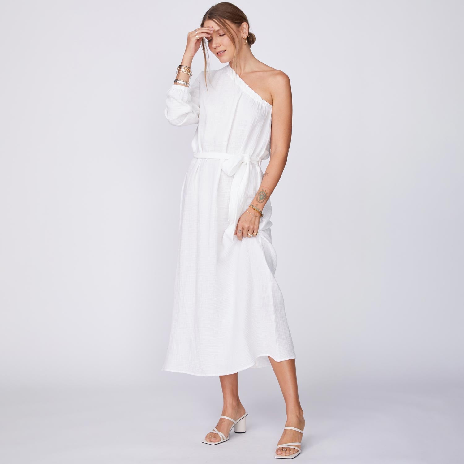 Side View of Model wearing the Gauze One Shoulder Dress in White