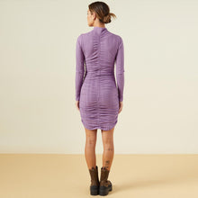 Back view of model wearing the flat rib mock shirred dress in aster purple.