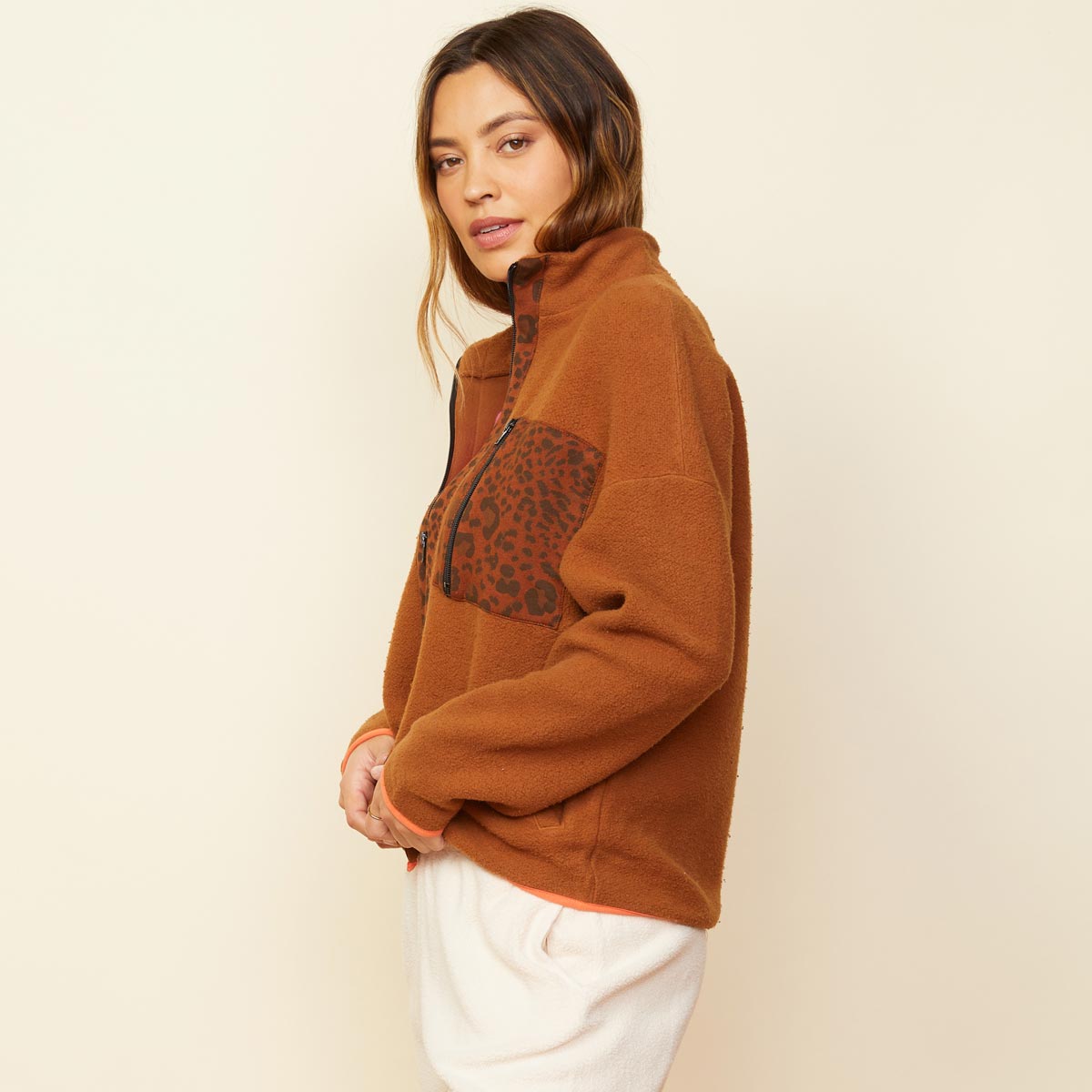 Side view of model wearing the leopard trim fleece jacket in caramel.