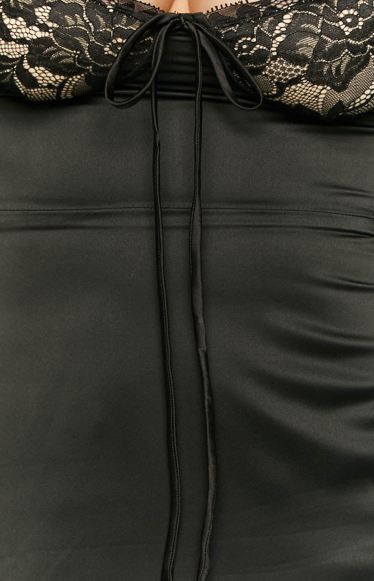 Side-back view of a black satin mini dress with a square back neckline, lace bust detail, and long flared sleeves