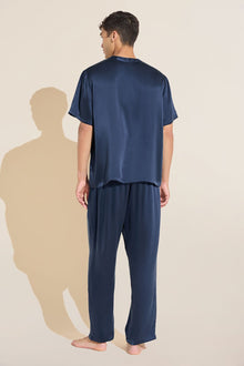 Model wears Charles Washable Silk Short Sleeve & Pant PJ Set in Navy.